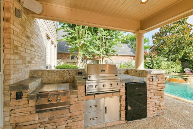 16050 Lockdale Ln, Cypress, TX 77429 - view of patio featuring exterior kitchen and a pool with connected hot tub