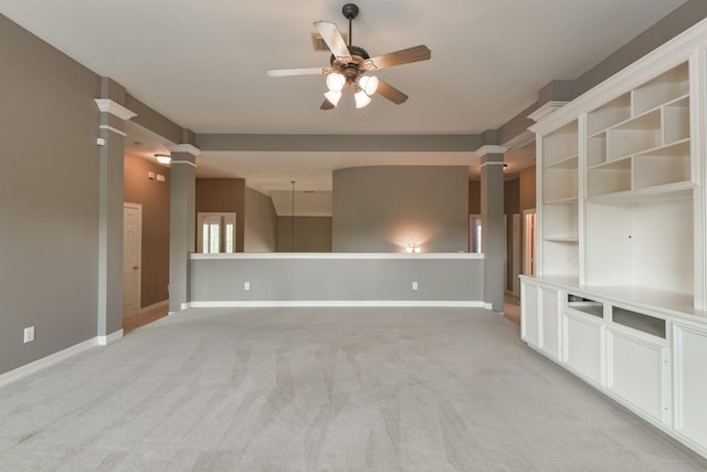 16050 Lockdale Ln, Cypress, TX 77429 - unfurnished living room with decorative columns, ceiling fan, and light carpet