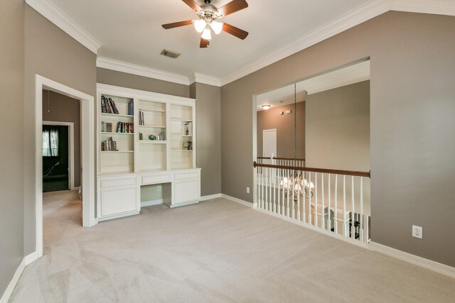 16050 Lockdale Ln, Cypress, TX 77429 - empty room with a ceiling fan, ornamental molding, built in study area, and light colored carpet