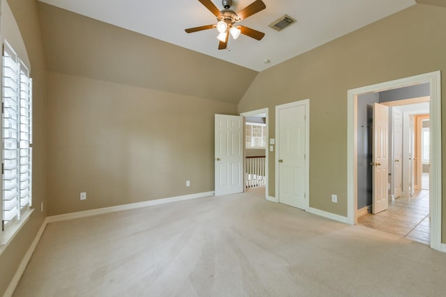 16050 Lockdale Ln, Cypress, TX 77429 - unfurnished bedroom with light carpet, vaulted ceiling, and a ceiling fan