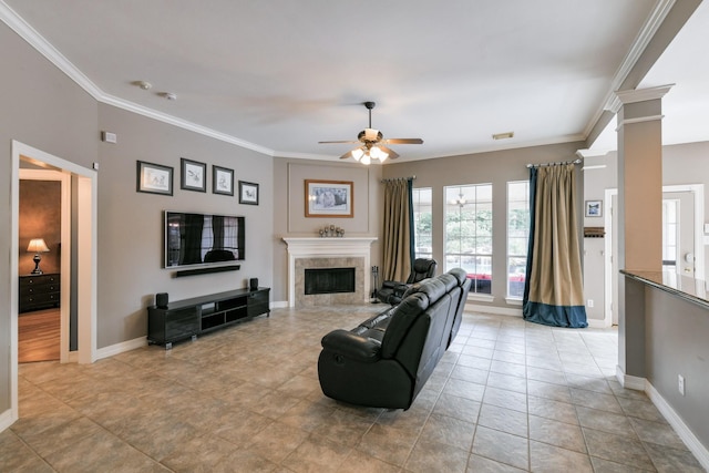 16050 Lockdale Ln, Cypress, TX 77429 - living room with ceiling fan, crown molding, decorative columns, and a tiled fireplace