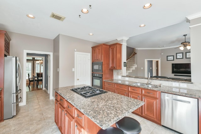 16050 Lockdale Ln, Cypress, TX 77429 - kitchen featuring black appliances, ceiling fan, recessed lighting, light stone counters, and brown cabinets