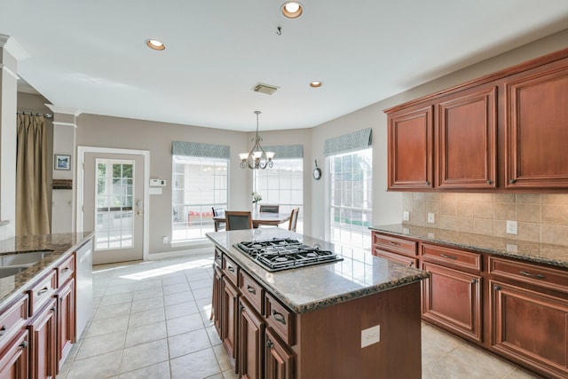 16050 Lockdale Ln, Cypress, TX 77429 - kitchen with gas stovetop, healthy amount of natural light, decorative backsplash, light tile patterned floors, and recessed lighting