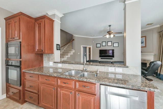 16050 Lockdale Ln, Cypress, TX 77429 - kitchen featuring black appliances, stone counters, brown cabinetry, open floor plan, and crown molding