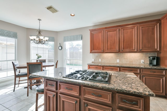 16050 Lockdale Ln, Cypress, TX 77429 - kitchen with stovetop with downdraft, a chandelier, healthy amount of natural light, decorative backsplash, and recessed lighting