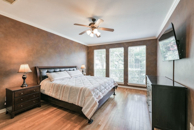 16050 Lockdale Ln, Cypress, TX 77429 - bedroom featuring light wood-style flooring, crown molding, and ceiling fan