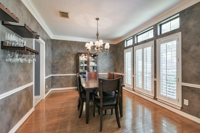16050 Lockdale Ln, Cypress, TX 77429 - dining room with wood finished floors, a chandelier, and crown molding