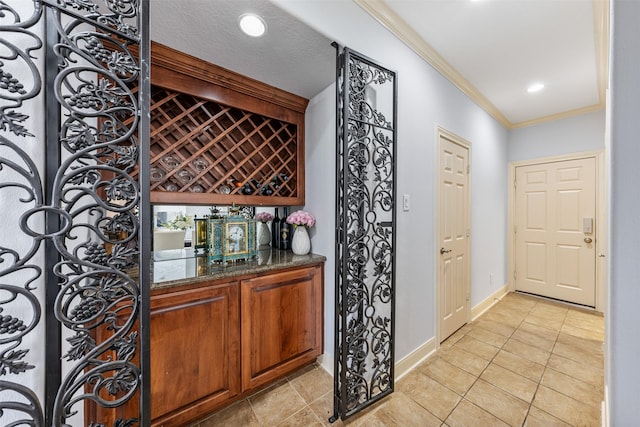 11710 Montmarte Blvd, Houston, TX 77082 - wine cellar featuring crown molding, a dry bar, light tile patterned floors, and recessed lighting