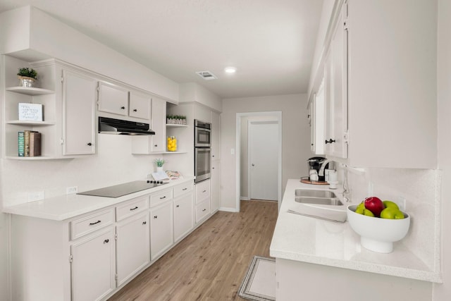 11258 Rousseau Dr, Houston, TX 77065 - kitchen with open shelves, black electric stovetop, under cabinet range hood, light wood-style floors, and light countertops