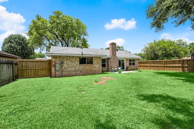 11258 Rousseau Dr, Houston, TX 77065 - back of property featuring brick siding, a chimney, a fenced backyard, and a shingled roof