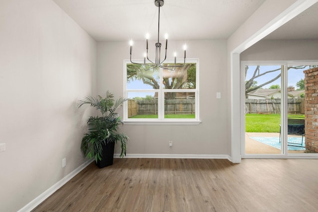 11258 Rousseau Dr, Houston, TX 77065 - unfurnished dining area with a chandelier and wood finished floors