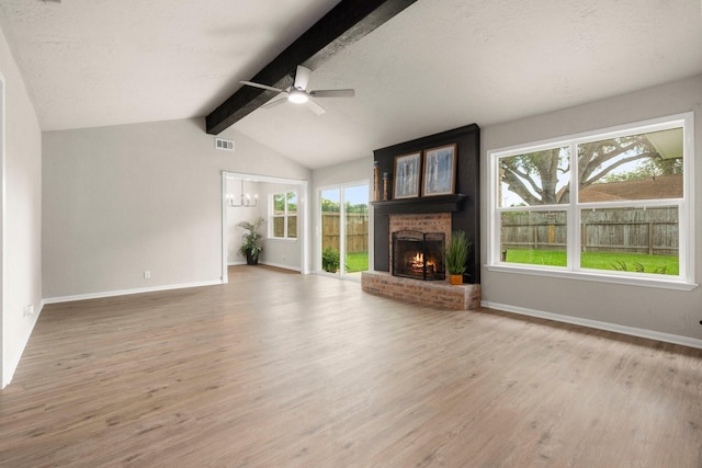11258 Rousseau Dr, Houston, TX 77065 - unfurnished living room featuring a brick fireplace, ceiling fan, and light wood-style flooring