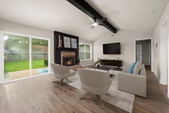 11258 Rousseau Dr, Houston, TX 77065 - living area featuring wood finished floors, a brick fireplace, and a ceiling fan