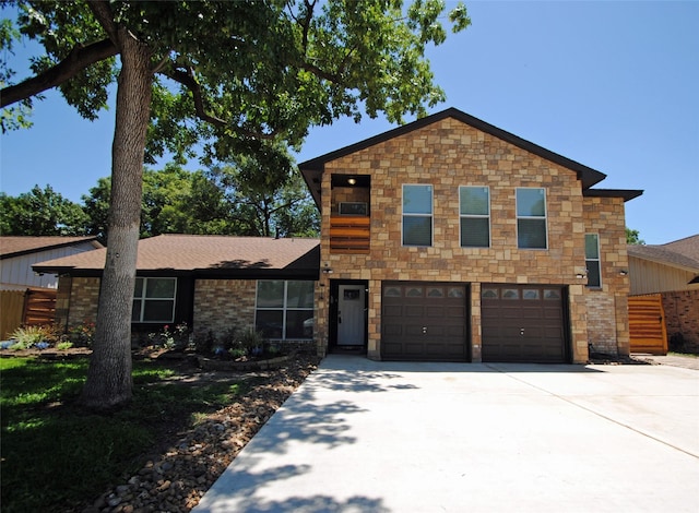 14306 Waterville Way, Houston, TX 77015 - view of front of home featuring concrete driveway, an attached garage, and stone siding