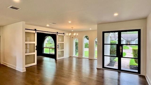 2823 Stetson Ln, Houston, TX 77043 - entryway with dark wood finished floors, a barn door, a chandelier, and recessed lighting