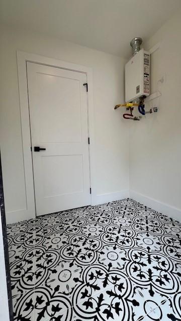 2823 Stetson Ln, Houston, TX 77043 - mudroom featuring tankless water heater and baseboards