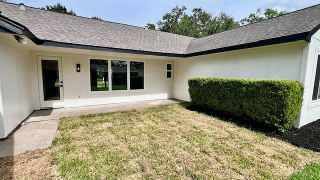 2823 Stetson Ln, Houston, TX 77043 - doorway to property featuring a lawn and a shingled roof