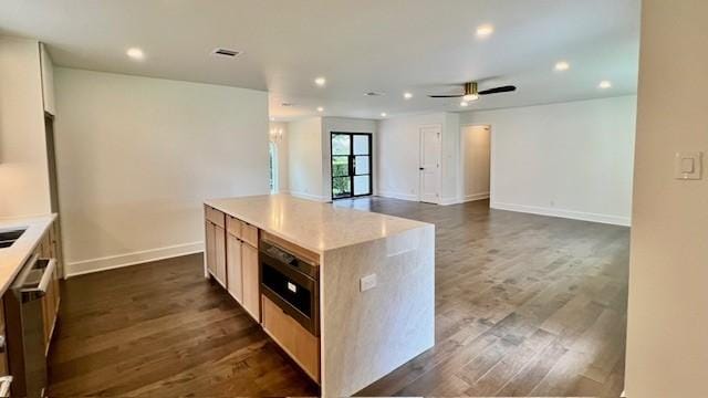 2823 Stetson Ln, Houston, TX 77043 - kitchen with dark wood finished floors, recessed lighting, ceiling fan, light countertops, and a center island