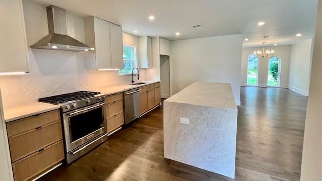 2823 Stetson Ln, Houston, TX 77043 - kitchen featuring stainless steel appliances, wall chimney exhaust hood, plenty of natural light, dark wood-style flooring, and recessed lighting