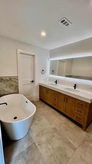 2823 Stetson Ln, Houston, TX 77043 - bathroom featuring double vanity and a freestanding tub