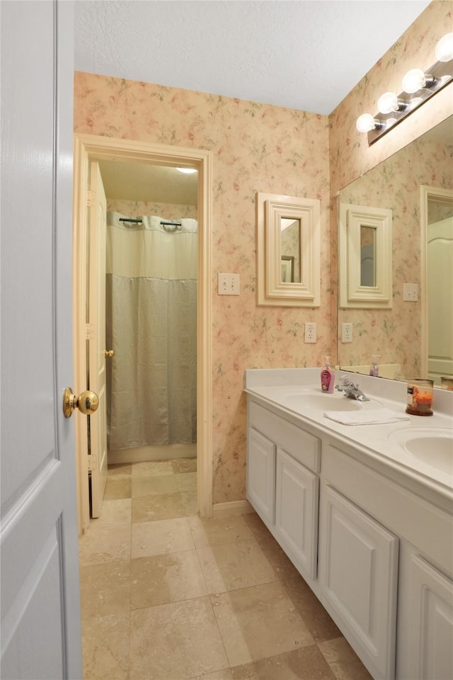 3816 Lake View Dr, Pearland, TX 77581 - full bath featuring wallpapered walls, double vanity, and a textured ceiling