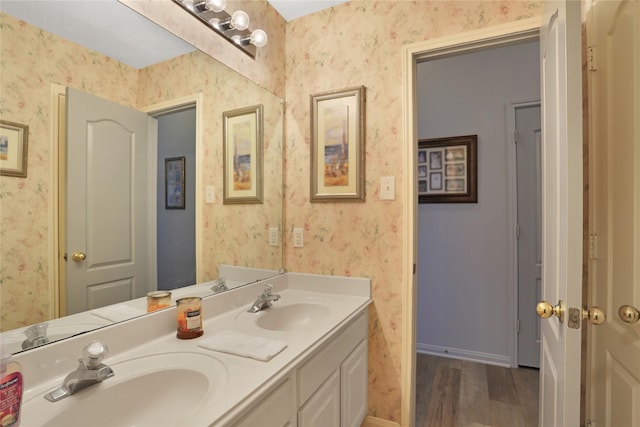 3816 Lake View Dr, Pearland, TX 77581 - bathroom featuring wallpapered walls, double vanity, and wood finished floors
