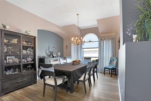 3816 Lake View Dr, Pearland, TX 77581 - dining space with a chandelier, wood finished floors, and arched walkways