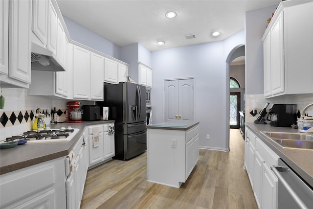 3816 Lake View Dr, Pearland, TX 77581 - kitchen featuring stainless steel dishwasher, fridge with ice dispenser, white gas cooktop, arched walkways, and white cabinetry