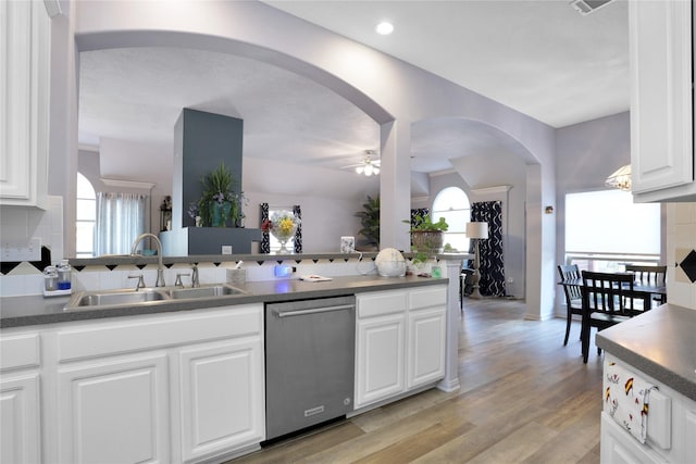 3816 Lake View Dr, Pearland, TX 77581 - kitchen with stainless steel dishwasher, arched walkways, ceiling fan, light wood-style flooring, and white cabinets