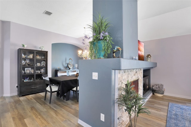 3816 Lake View Dr, Pearland, TX 77581 - office area with wood finished floors, a chandelier, a lit fireplace, and arched walkways