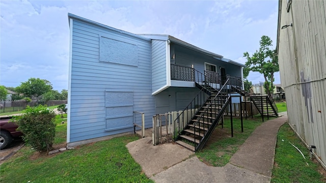 5625 Antoine Dr Unit 606, Houston, TX 77091 - back of house featuring stairway and a lawn
