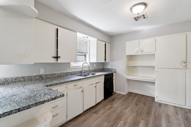 122 22nd Ave N, Texas City, TX 77590 - kitchen featuring black dishwasher, light wood-style floors, white cabinets, and stone counters