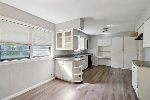 122 22nd Ave N, Texas City, TX 77590 - kitchen featuring open shelves, light wood-style flooring, white cabinetry, and black dishwasher