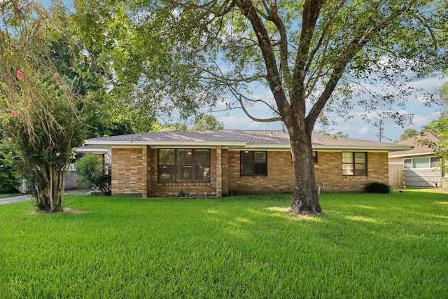 122 22nd Ave N, Texas City, TX 77590 - ranch-style house with a front yard and brick siding