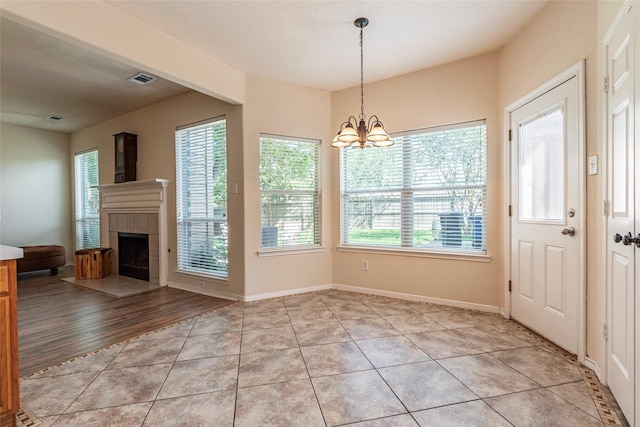 2013 Port Bridge Ln, League City, TX 77573 - entrance foyer featuring a chandelier, a tiled fireplace, and light tile patterned floors