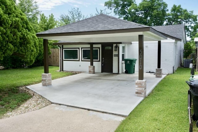 5010 Malmedy Rd, Houston, TX 77033 - view of front facade featuring roof with shingles, driveway, and a carport