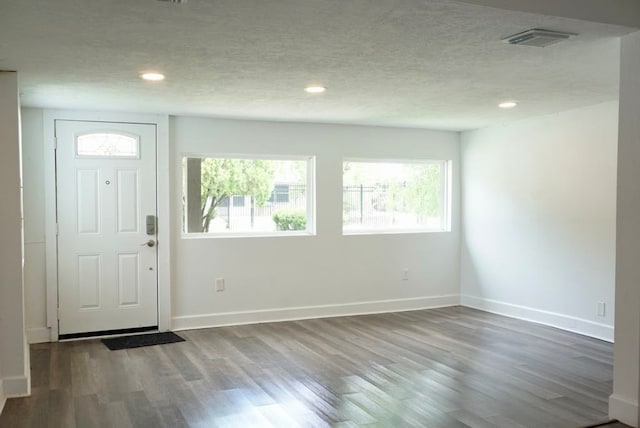 5010 Malmedy Rd, Houston, TX 77033 - entryway featuring wood finished floors, recessed lighting, and a textured ceiling