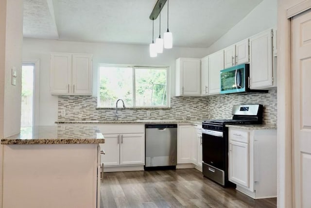 5010 Malmedy Rd, Houston, TX 77033 - kitchen with appliances with stainless steel finishes, white cabinets, light stone countertops, dark wood-style floors, and tasteful backsplash