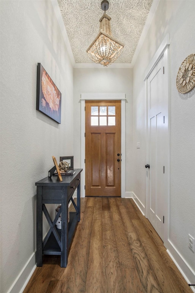 1929 Spanish Moss Dr, College Station, TX 77845 - entryway featuring dark wood-style floors, ornamental molding, and a chandelier