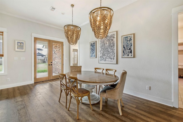 1929 Spanish Moss Dr, College Station, TX 77845 - dining room featuring a chandelier, dark wood finished floors, healthy amount of natural light, ornamental molding, and french doors