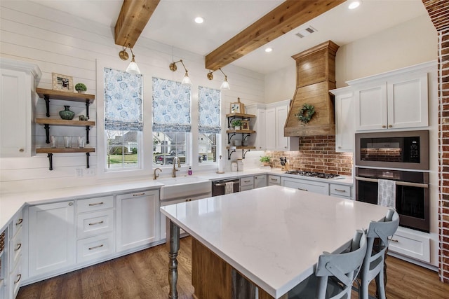 1929 Spanish Moss Dr, College Station, TX 77845 - kitchen featuring open shelves, stainless steel appliances, a kitchen bar, white cabinets, and dark wood finished floors