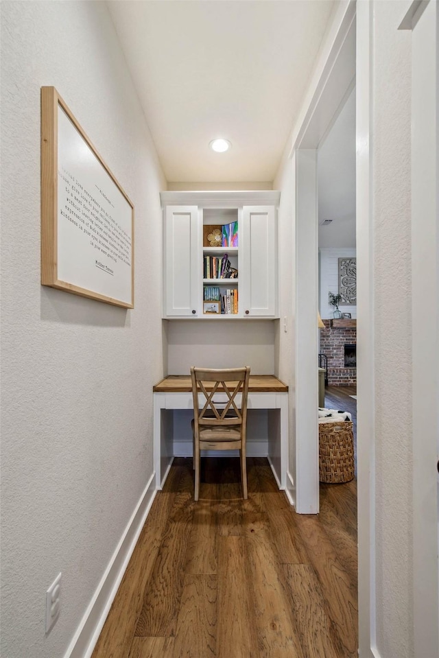 1929 Spanish Moss Dr, College Station, TX 77845 - hall featuring dark wood-type flooring, recessed lighting, and a desk
