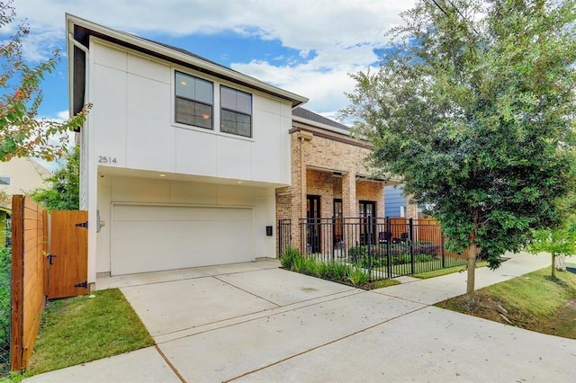 2514 Detering St, Houston, TX 77007 - view of front of home featuring an attached garage, driveway, and brick siding