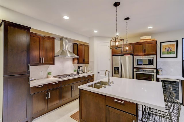 2514 Detering St, Houston, TX 77007 - kitchen with appliances with stainless steel finishes, wall chimney exhaust hood, wine cooler, light countertops, and hanging light fixtures