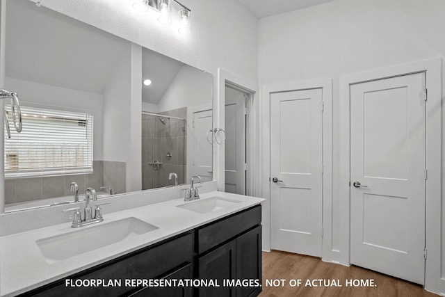20626 Draper Rd, Tomball, TX 77377 - bathroom with a tile shower, double vanity, wood finished floors, and lofted ceiling