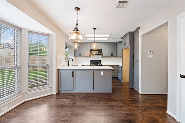 7015 Redwood Falls Dr, Pasadena, TX 77505 - kitchen featuring gray cabinetry, black microwave, range, and a peninsula