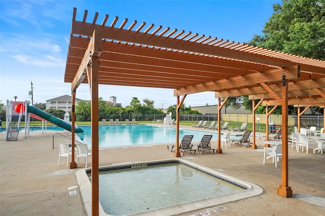7015 Redwood Falls Dr, Pasadena, TX 77505 - community pool featuring a pergola, a water slide, and a patio area