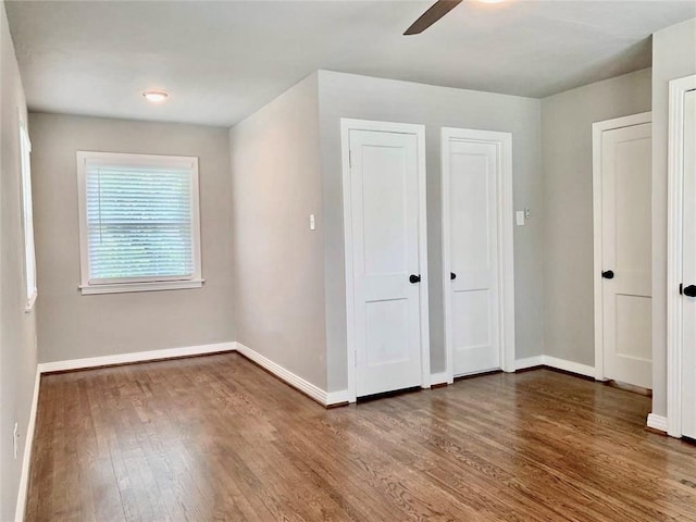 142 Beverly Ln, Bellaire, TX 77401 - unfurnished bedroom featuring wood finished floors and ceiling fan