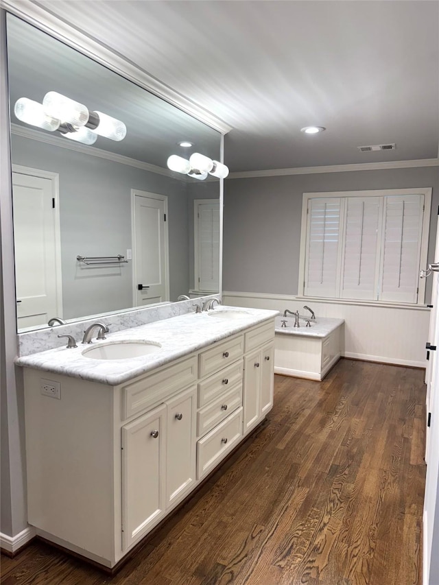 142 Beverly Ln, Bellaire, TX 77401 - full bath with ornamental molding, double vanity, wood finished floors, and recessed lighting