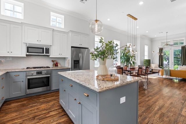 5658 Darling St, Houston, TX 77007 - kitchen with appliances with stainless steel finishes, gray cabinets, dark wood-style floors, a ceiling fan, and crown molding
